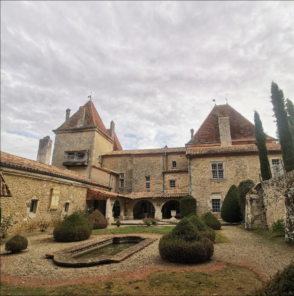 Cour intérieure du Château de Malvirade, galerie à arcades, bassin et topiaires